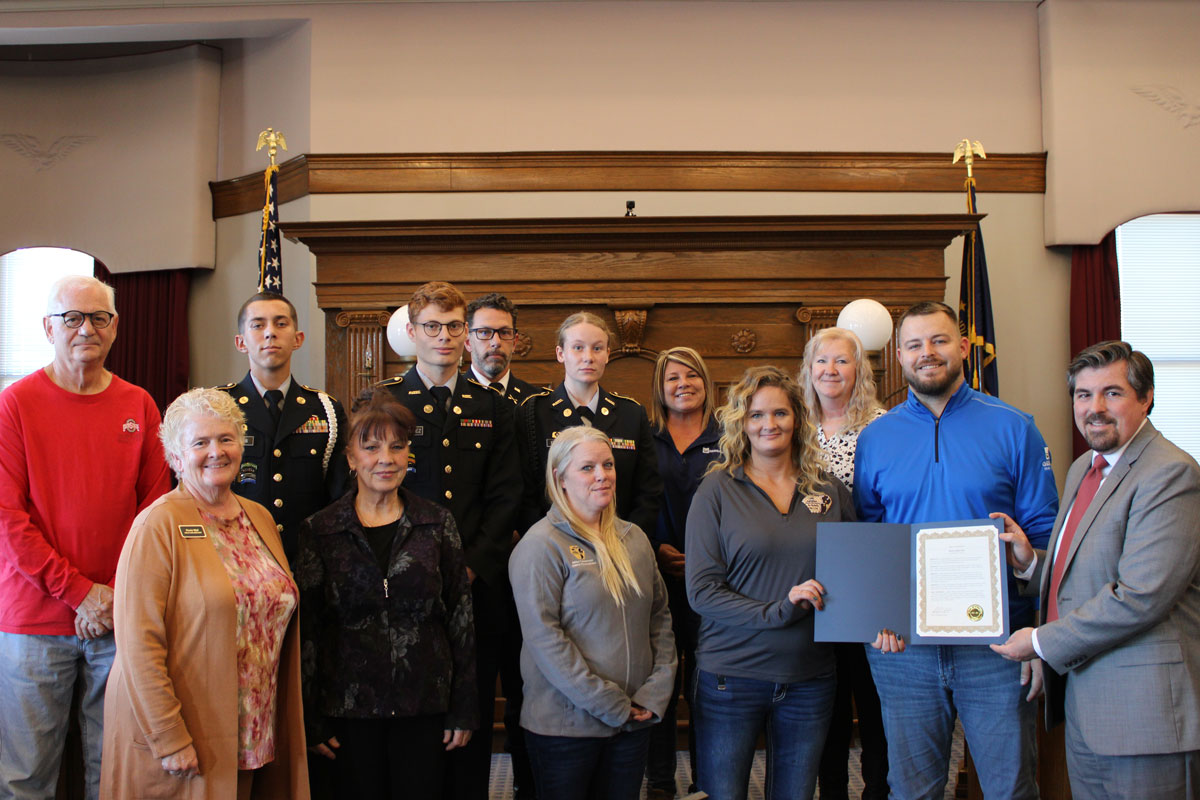 A group of volunteers who were recognized on Extra Mile Day are photographed with Mayor Richard Strick.